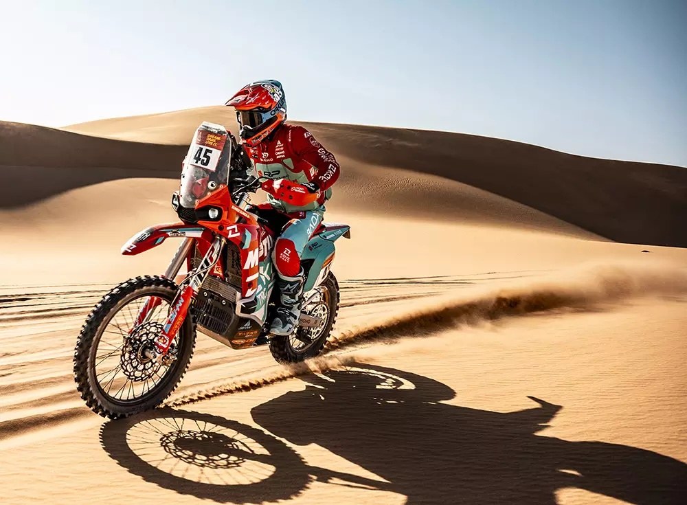 KOVE rally motorcycle riding through desert sand